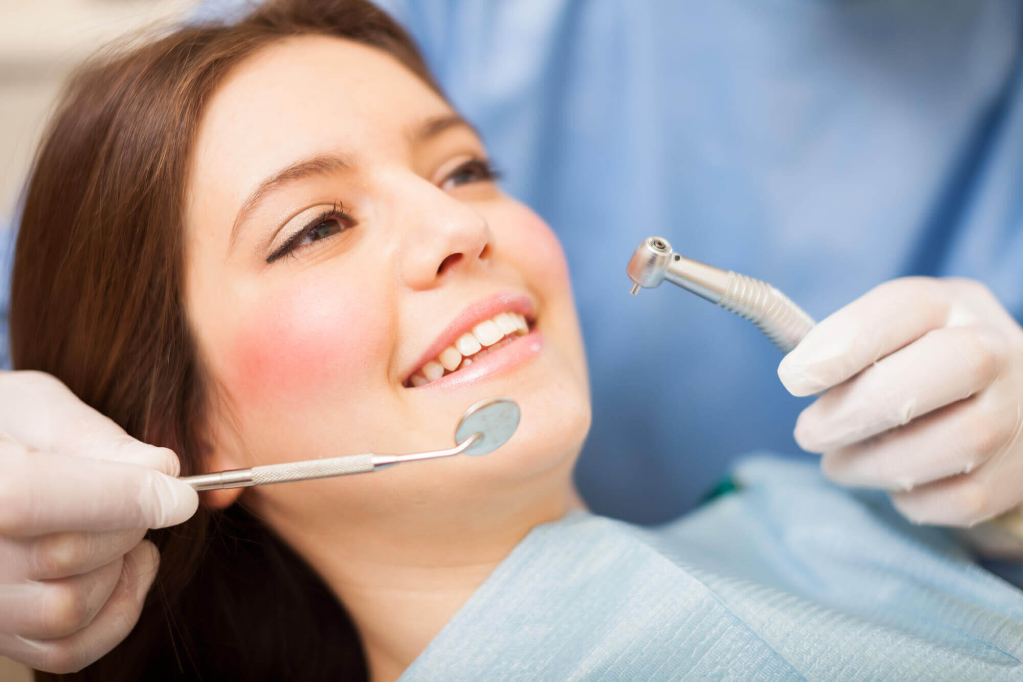 affordable Miami dentist cleaning a woman's teeth